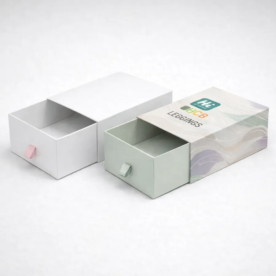 Two slide-out drawer boxes with ribbon pulls- one plain white and one with patterned sleeves- class=